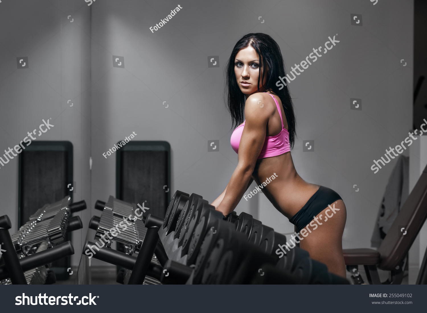 stock photo brunette fitness woman in black sport wear with perfect fitness body in gym 255049102